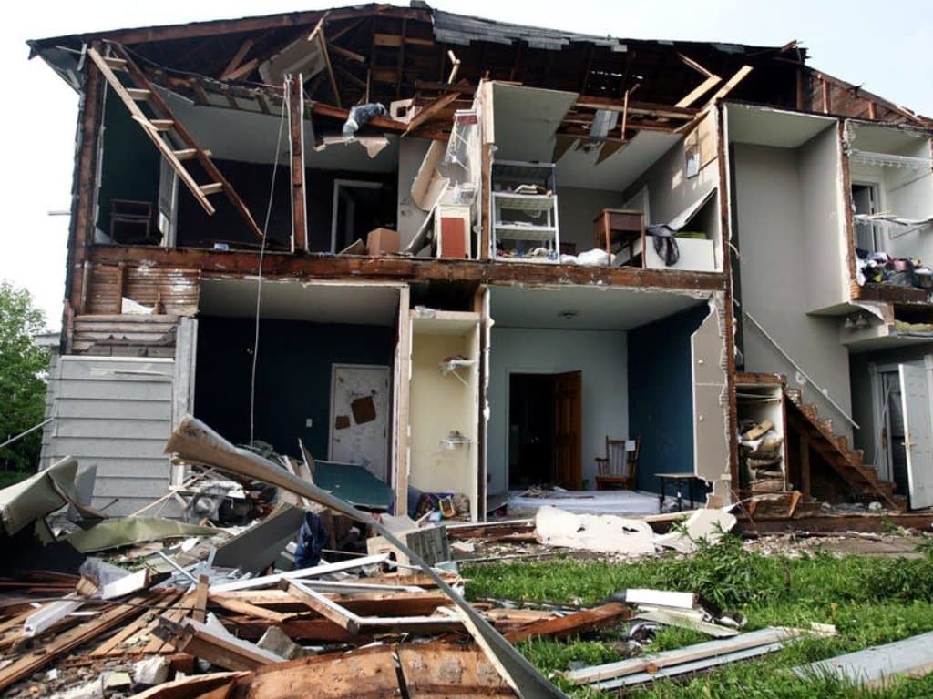 Apartment building torn open by hurricane wind, documented for an insurance claim