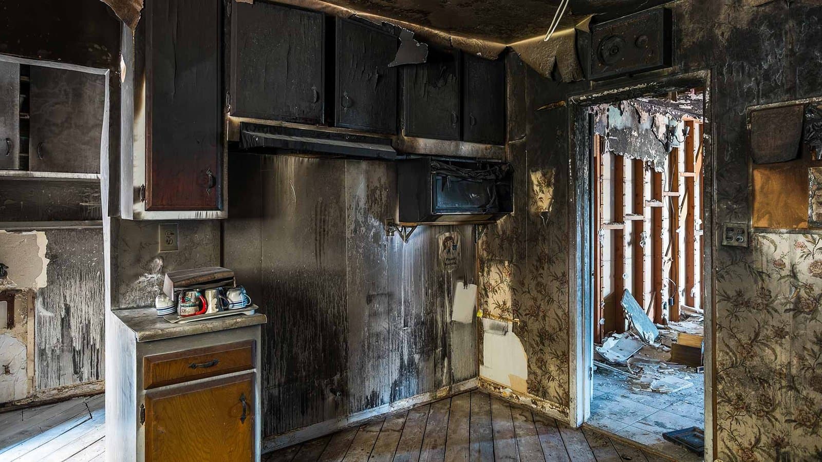 Kitchen blackened by smoke and soot after a house fire in the Houston area